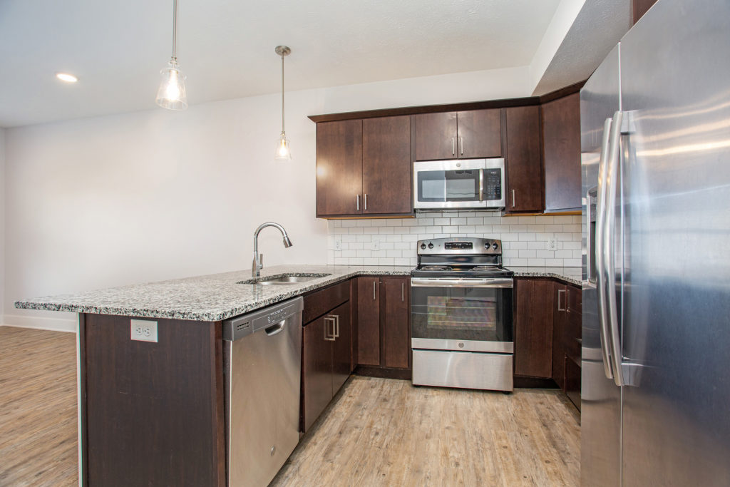 Spacious kitchen with stainless steel appliances and granite countertops