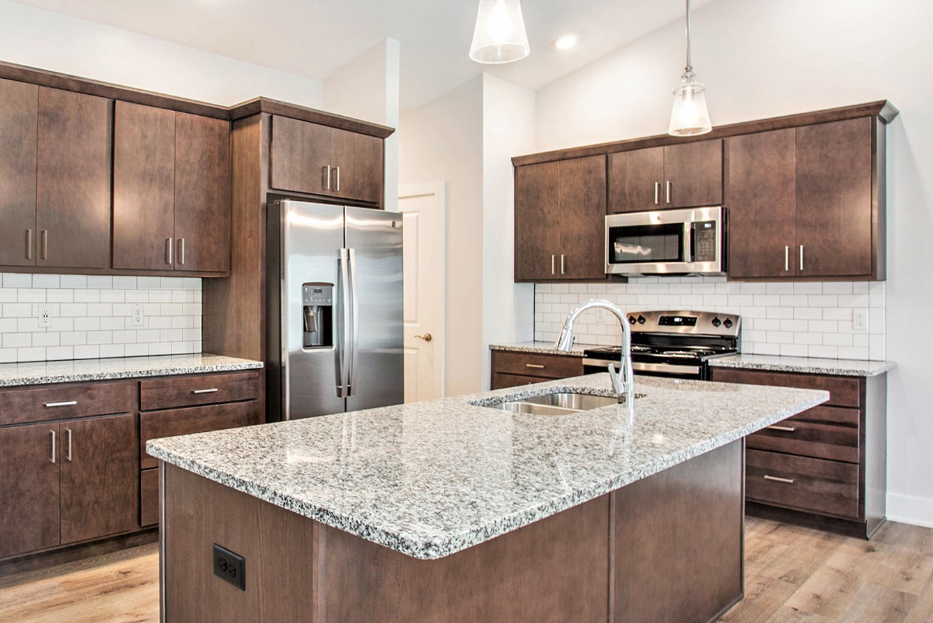 Spacious kitchen with stainless steel appliances and granite countertops